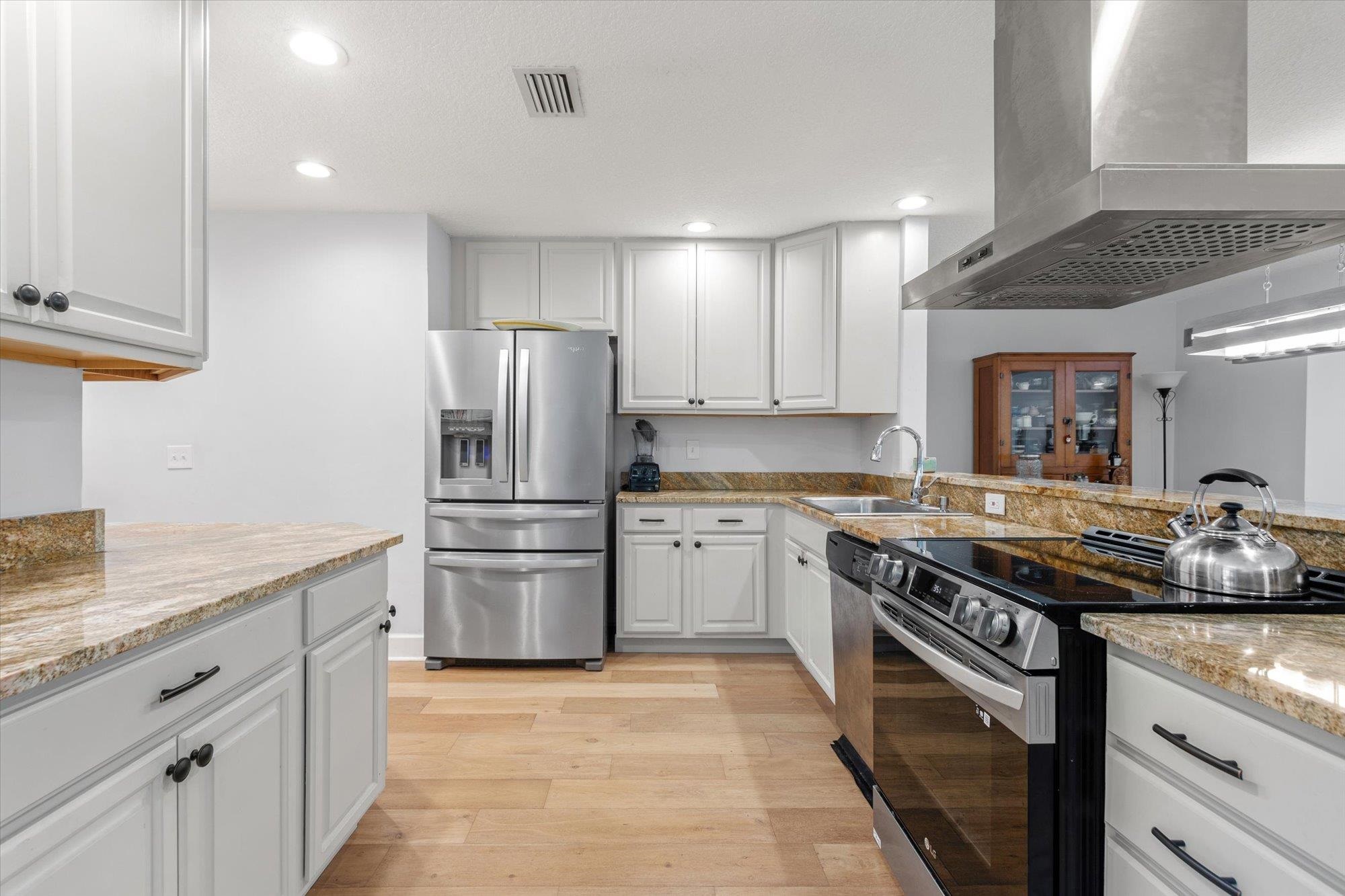 200 Raintree Trail St. Augustine, FL 32086 - Photo 13 of 36 a kitchen with stainless steel appliances granite countertop a stove and a refrigerator