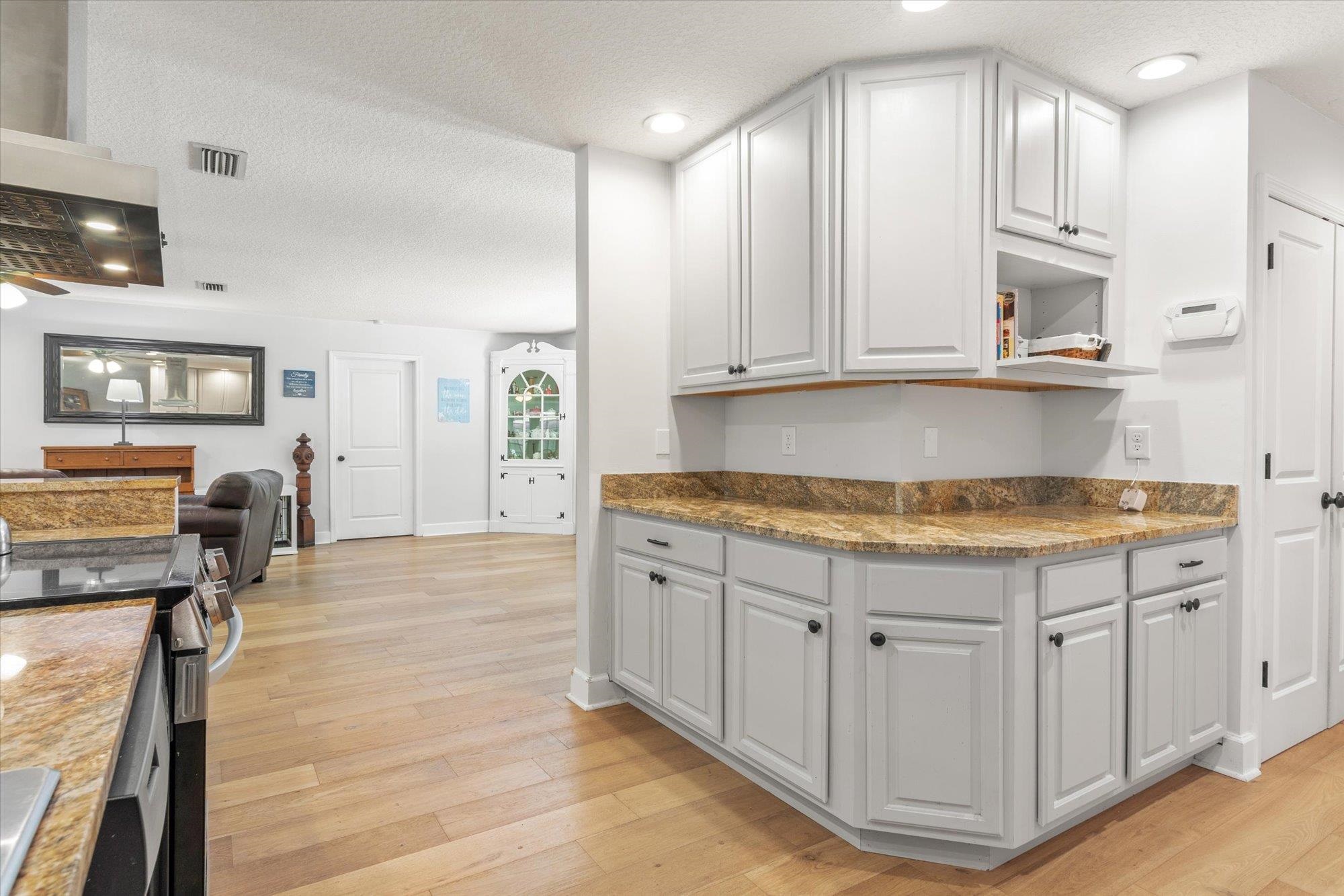 200 Raintree Trail St. Augustine, FL 32086 - Photo 14 of 36 a kitchen with granite countertop a sink a stove cabinets and wooden floor