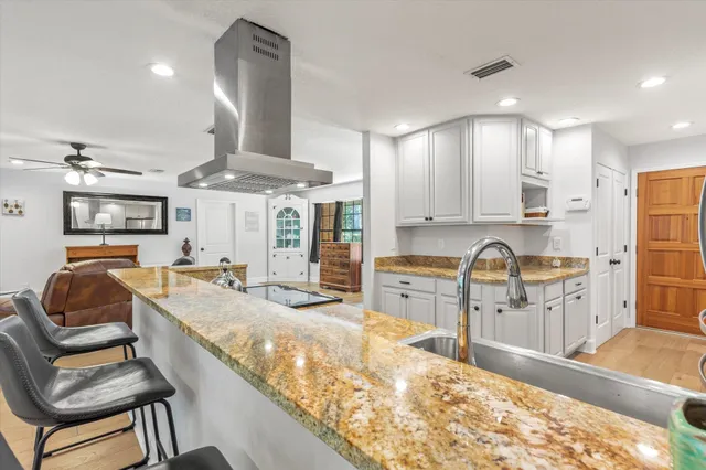 a kitchen with stainless steel appliances granite countertop a sink and cabinets