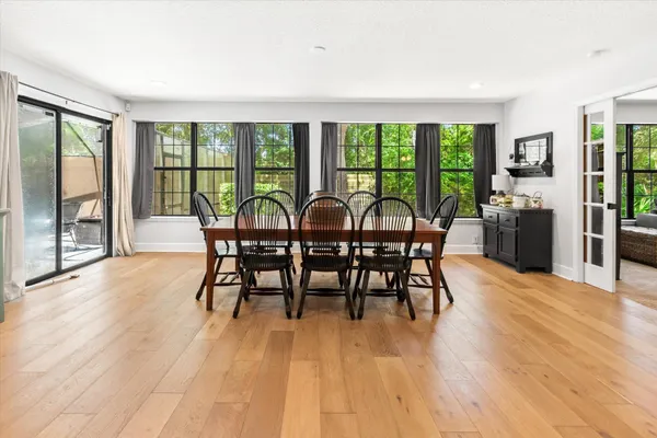 a view of a dining room with furniture window and wooden floor
