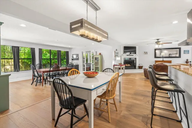a dining room with furniture a chandelier and wooden floor