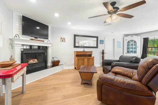 a living room with furniture a fireplace and a flat screen tv
