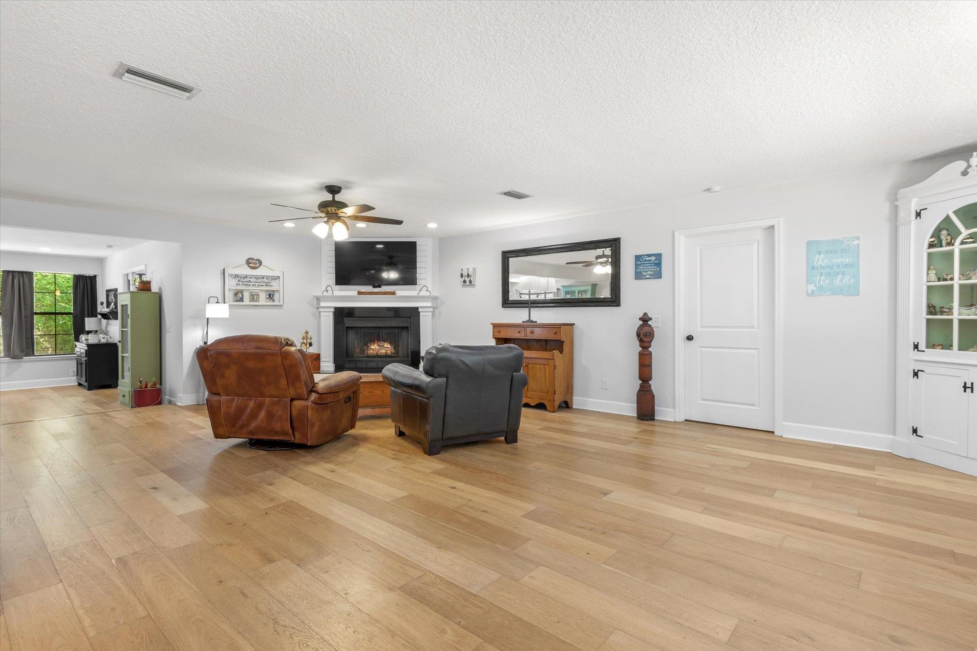 200 Raintree Trail St. Augustine, FL 32086 - Photo 22 of 36 a living room with furniture and a fireplace