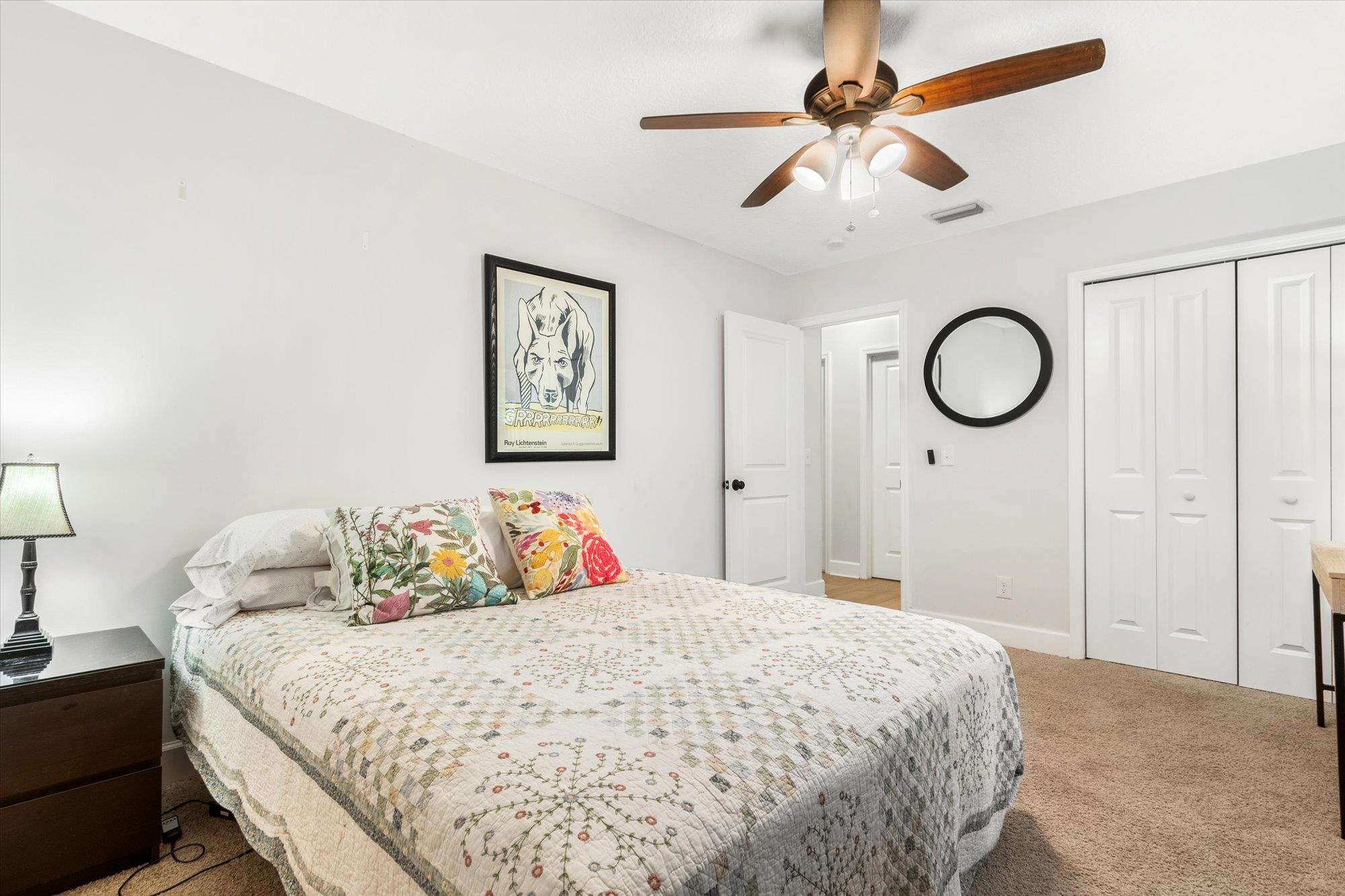 200 Raintree Trail St. Augustine, FL 32086 - Photo 30 of 36 a bedroom with a bed and a chandelier