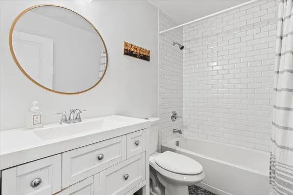 a bathroom with a sink a toilet and a mirror