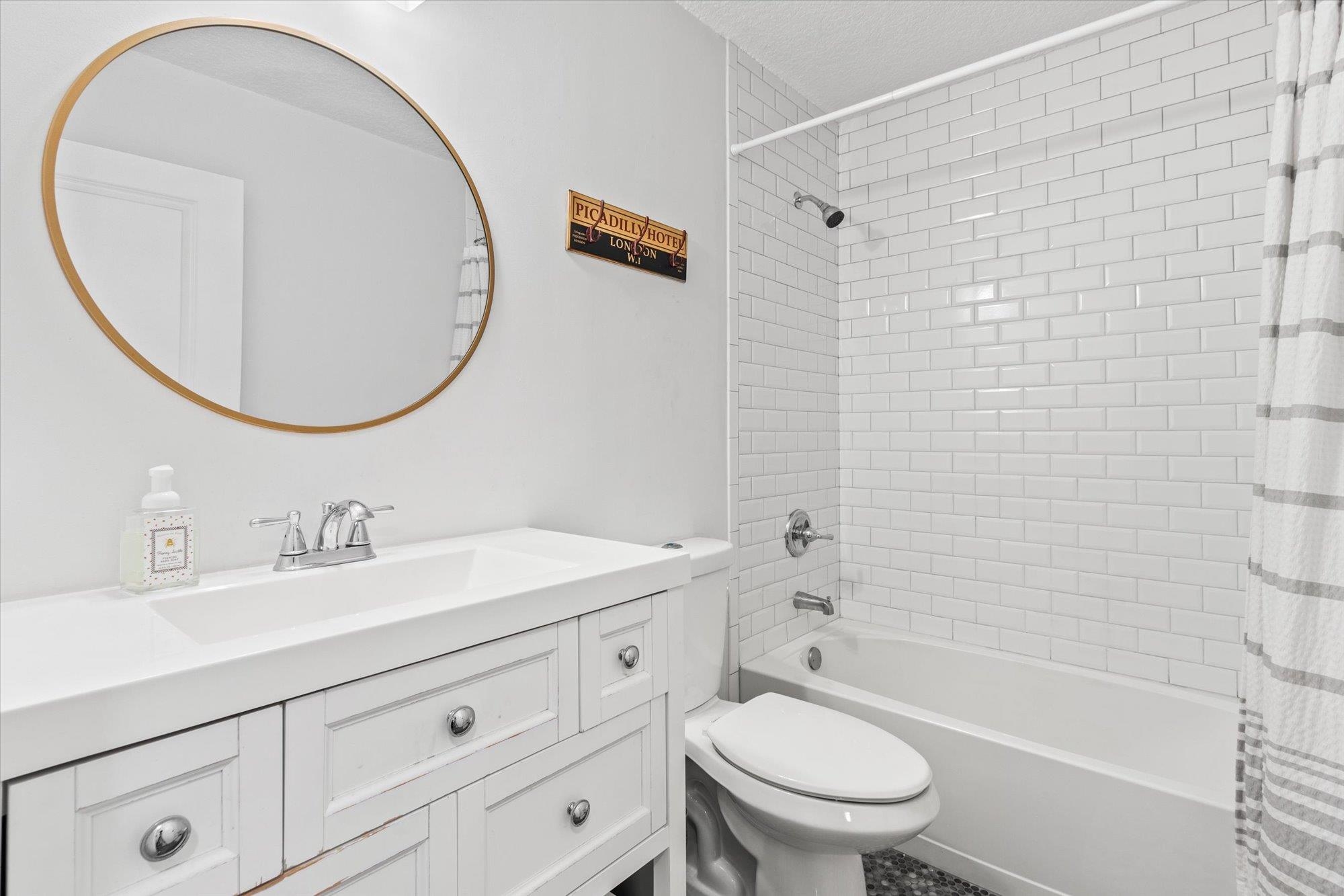 200 Raintree Trail St. Augustine, FL 32086 - Photo 31 of 36 a bathroom with a sink a toilet and a mirror