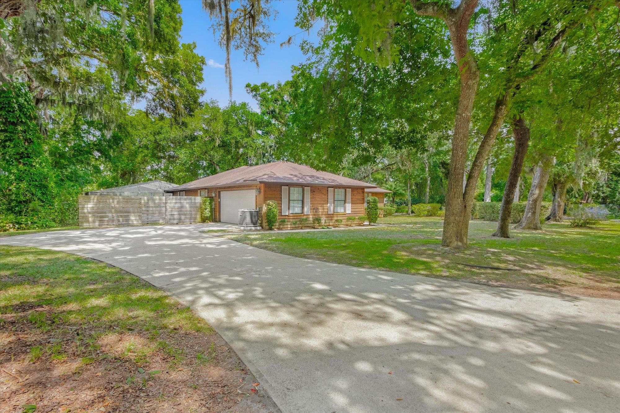 200 Raintree Trail St. Augustine, FL 32086 - Photo 34 of 36 a front view of a house with yard and green space