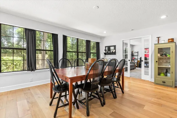a view of a dining room with furniture window and wooden floor