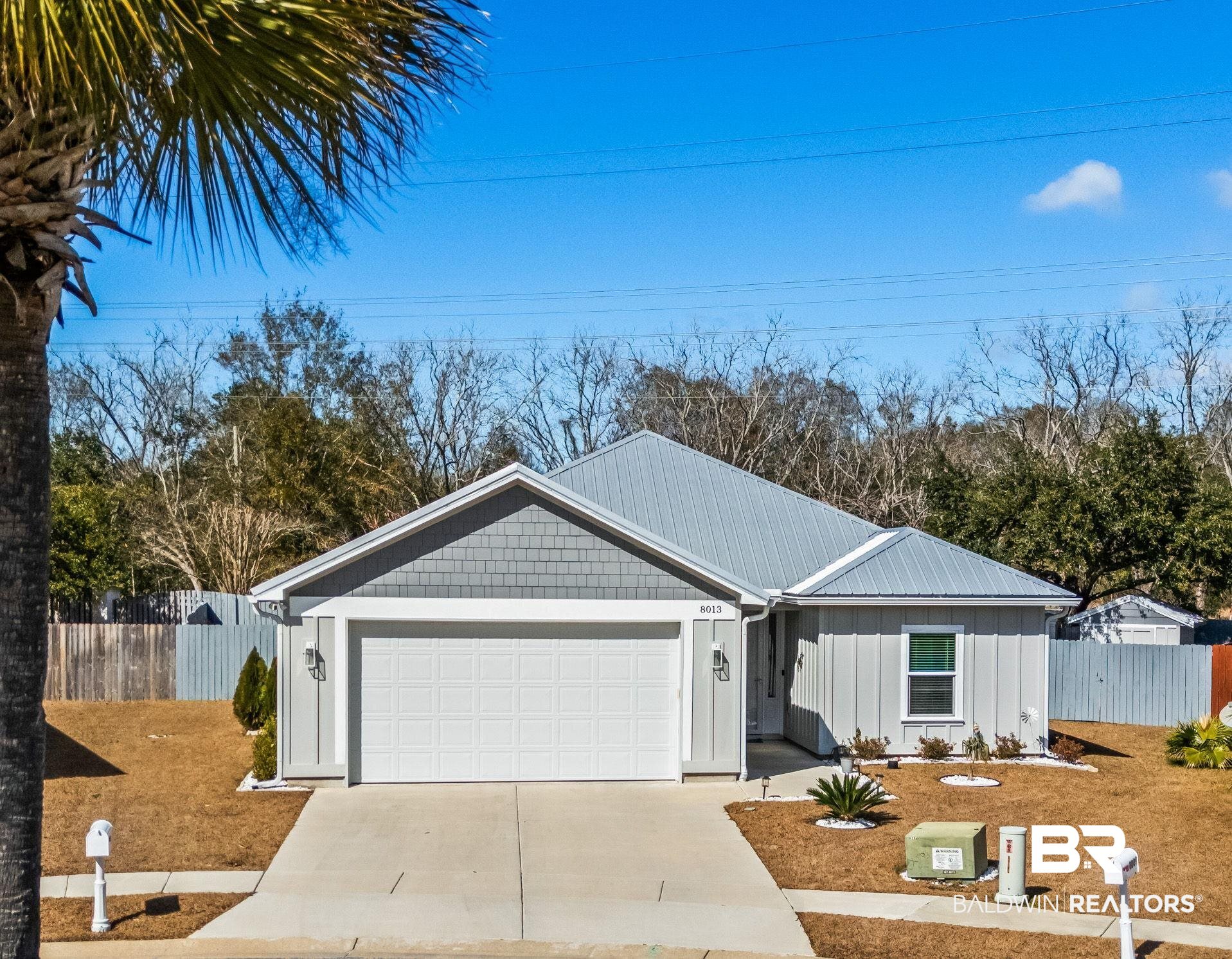 8013 Carmel Circle Foley, AL 36535 - Photo 1 of 49 Ranch-style house with an attached garage, board and batten siding, and concrete driveway