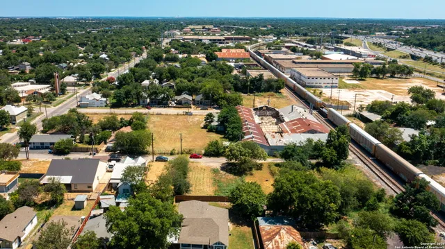 an aerial view of residential houses with outdoor space