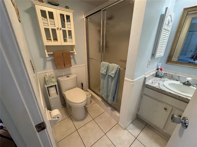 a bathroom with a toilet a sink and a mirror