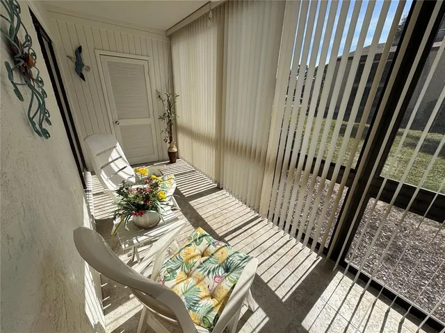 a view of a balcony with chairs