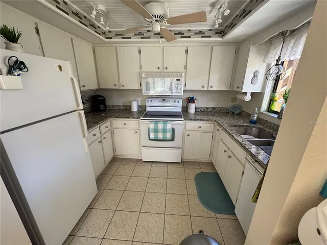 a kitchen with stainless steel appliances a refrigerator a sink a stove a microwave and cabinets