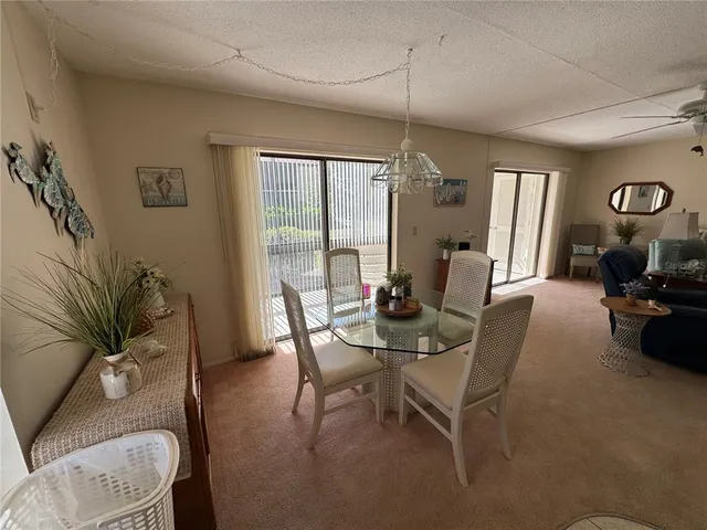 a living room with furniture a table and a large window
