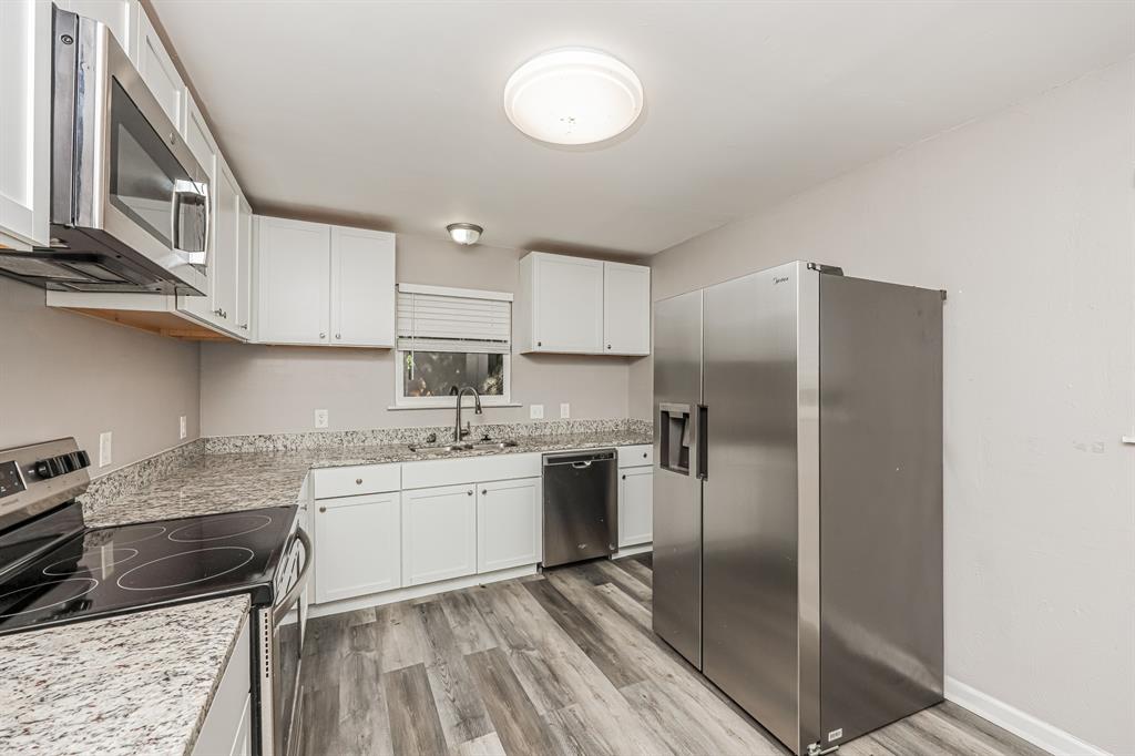 2155 Gaylord Drive Dallas, TX 75227 - Photo 12 of 21 a kitchen with a sink stainless steel appliances and cabinets