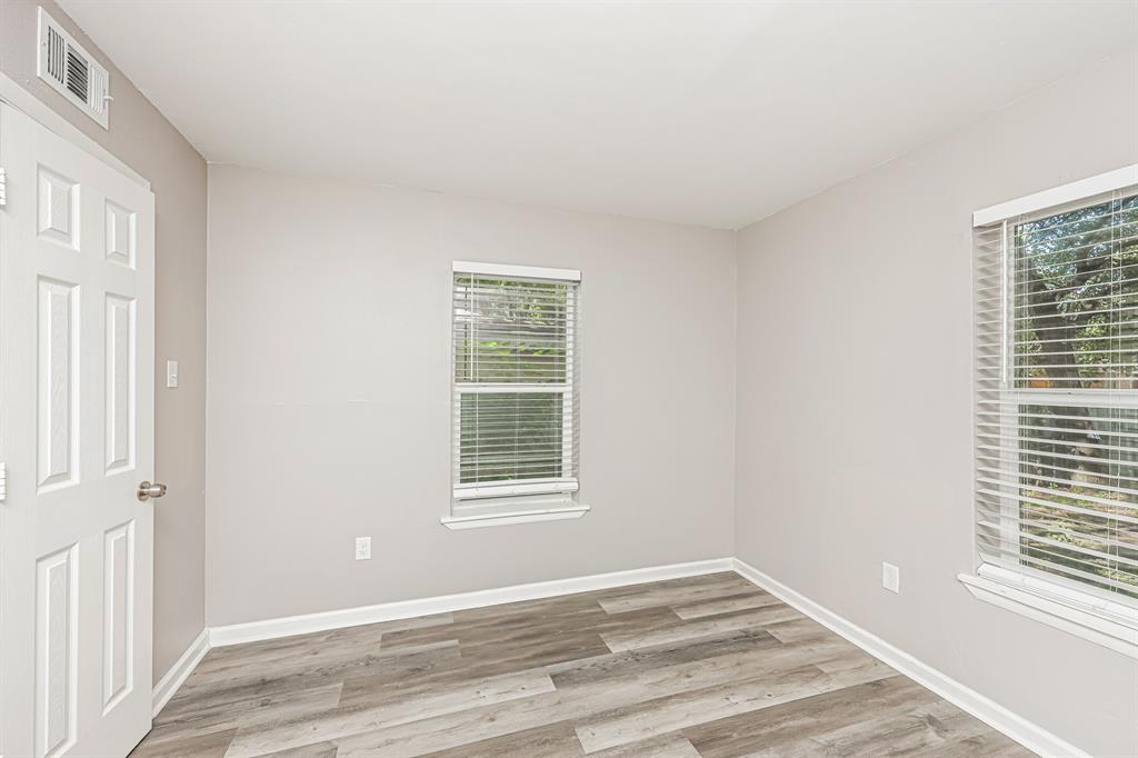 2155 Gaylord Drive Dallas, TX 75227 - Photo 18 of 21 a view of an empty room with wooden floor and a window