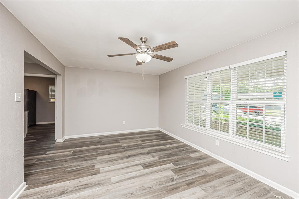 2155 Gaylord Drive Dallas, TX 75227 - Photo 6 of 21 a view of an empty room with a window and a ceiling fan