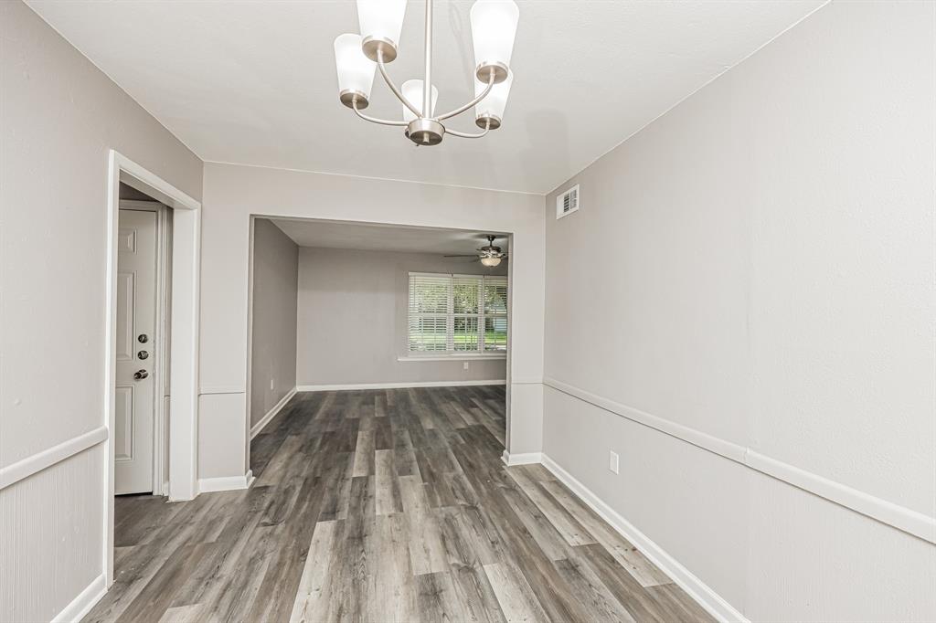 2155 Gaylord Drive Dallas, TX 75227 - Photo 10 of 21 a view of wooden floor chandelier and window in a room