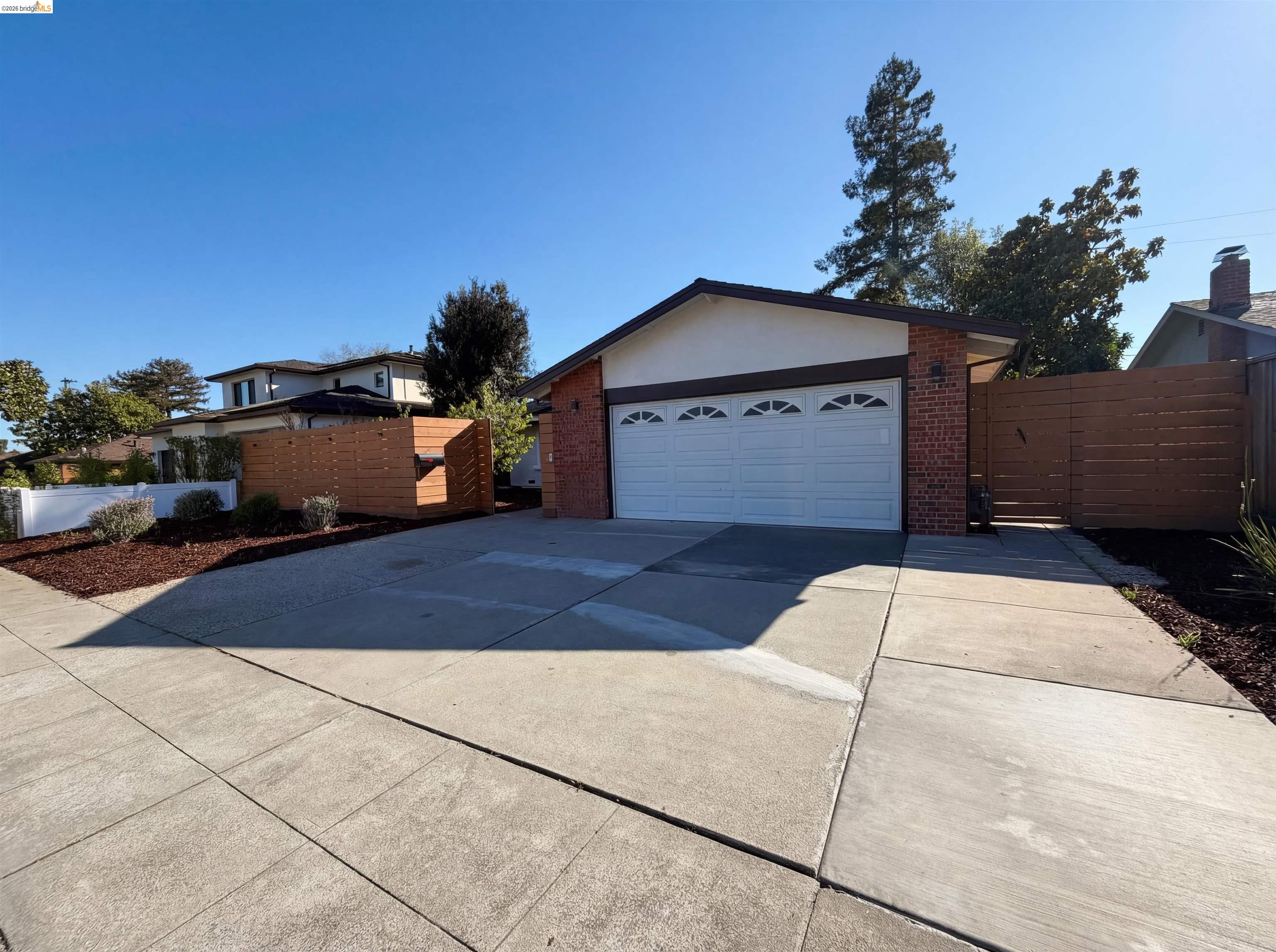1564 South Wolfe Road Sunnyvale, CA 94087 - Photo 13 of 27 View of front of property featuring brick siding, a gate, and driveway