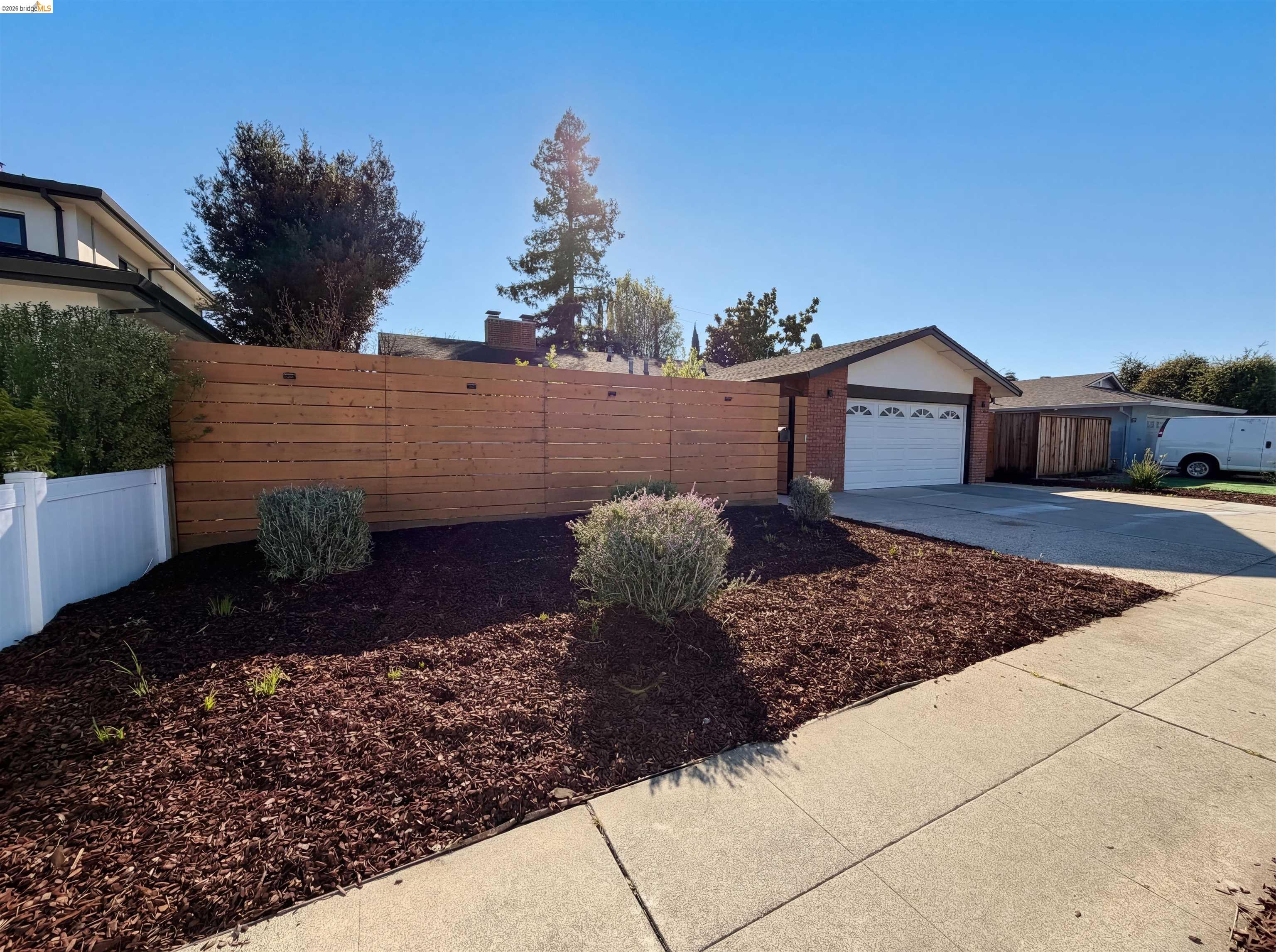 1564 South Wolfe Road Sunnyvale, CA 94087 - Photo 14 of 27 View of yard featuring concrete driveway and an attached garage