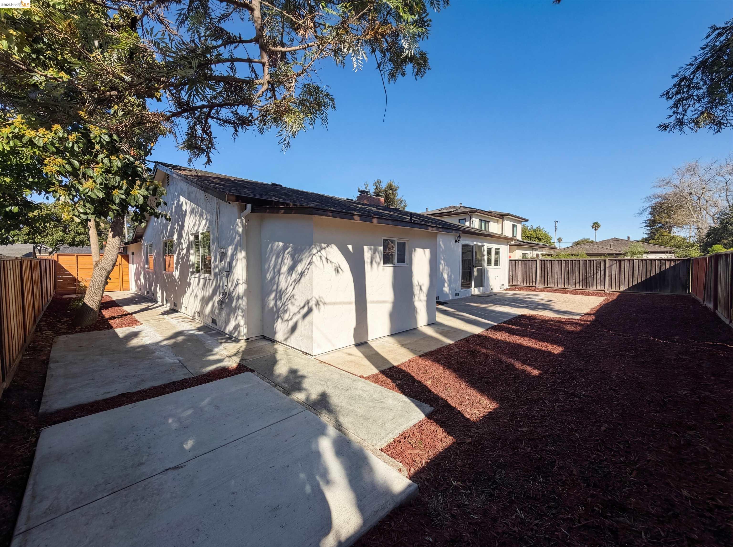1564 South Wolfe Road Sunnyvale, CA 94087 - Photo 26 of 27 Rear view of property featuring a fenced backyard, stucco siding, and a chimney