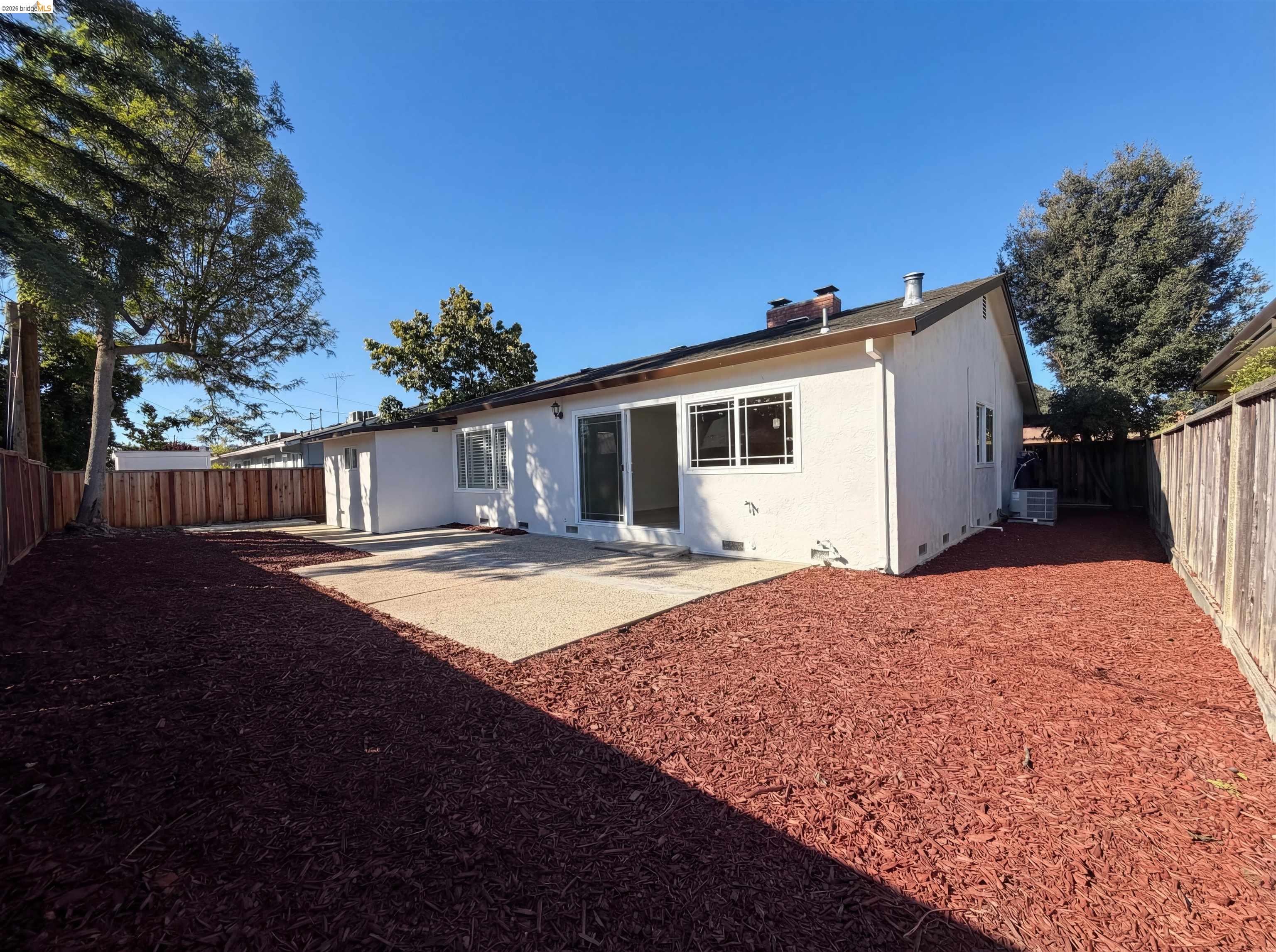 1564 South Wolfe Road Sunnyvale, CA 94087 - Photo 5 of 27 Back of property with a patio, a fenced backyard, stucco siding, and a chimney