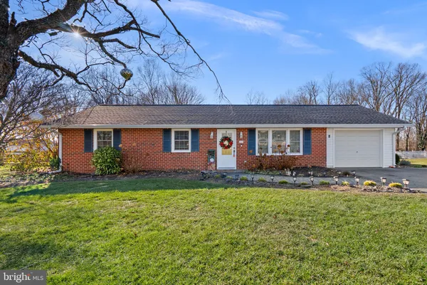 a front view of house with yard and trees