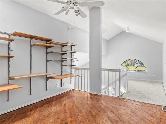 a view of empty room with a ceiling fan
