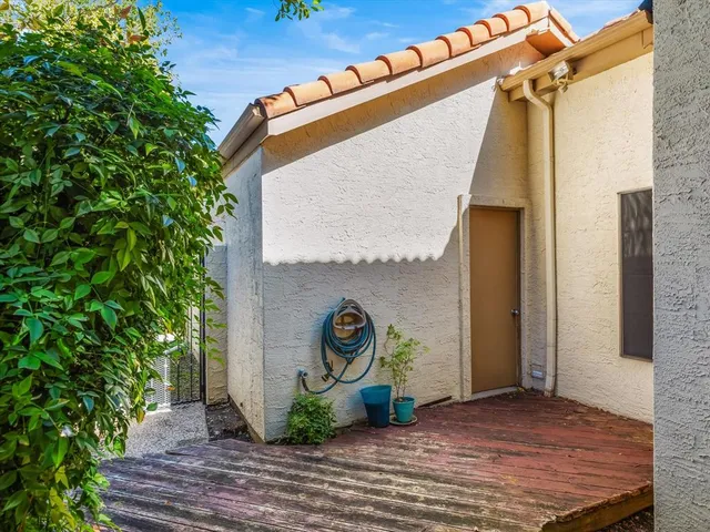 a view of a door of the house and potted plants