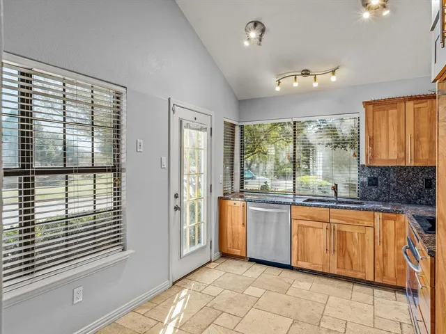 a large white kitchen with a large window