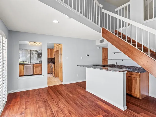 a view of entryway and hall with wooden floor