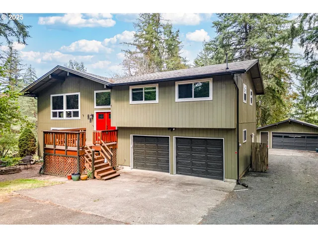 a view of a house with a yard and garage