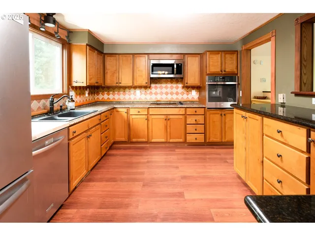 a kitchen with granite countertop a sink and a window