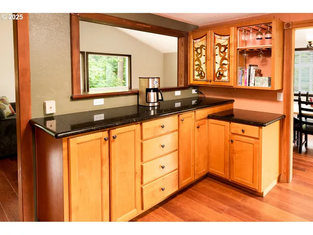 a view of open kitchen with granite countertop sink and cabinets
