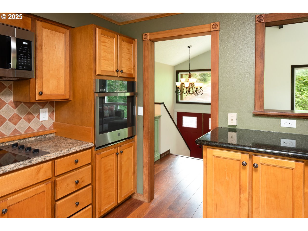 3503 Northwest Valley View Drive Albany, OR 97321 - Photo 29 of 43 a kitchen with granite countertop wooden cabinets a stove a sink and a large window