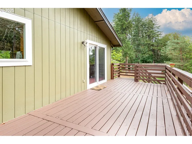 a view of backyard with deck and wooden floor