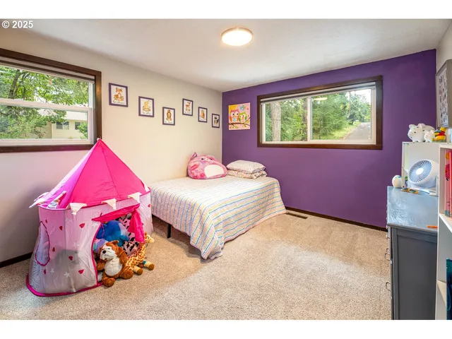 a spacious bedroom with a bed and window