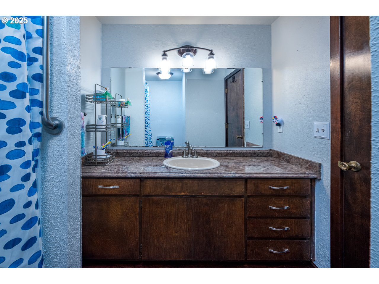 3503 Northwest Valley View Drive Albany, OR 97321 - Photo 33 of 43 a bathroom with a granite countertop sink a large mirror and a shower