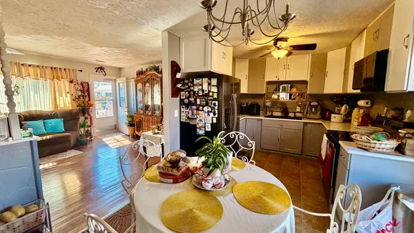 a view of a dining room with furniture and a chandelier