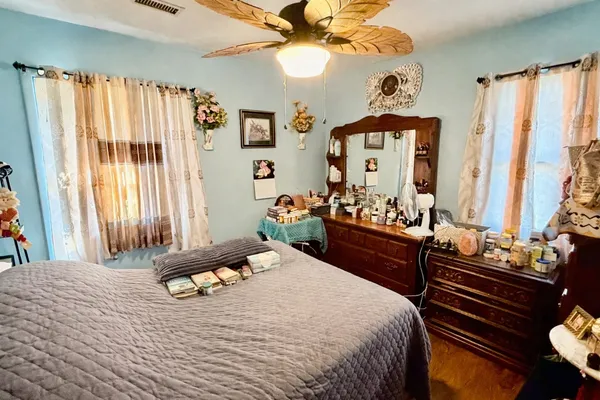 a bedroom with a bed and a chandelier