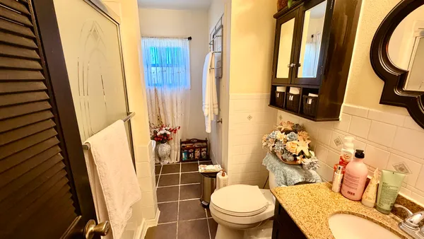 a bathroom with a toilet and a shower curtain