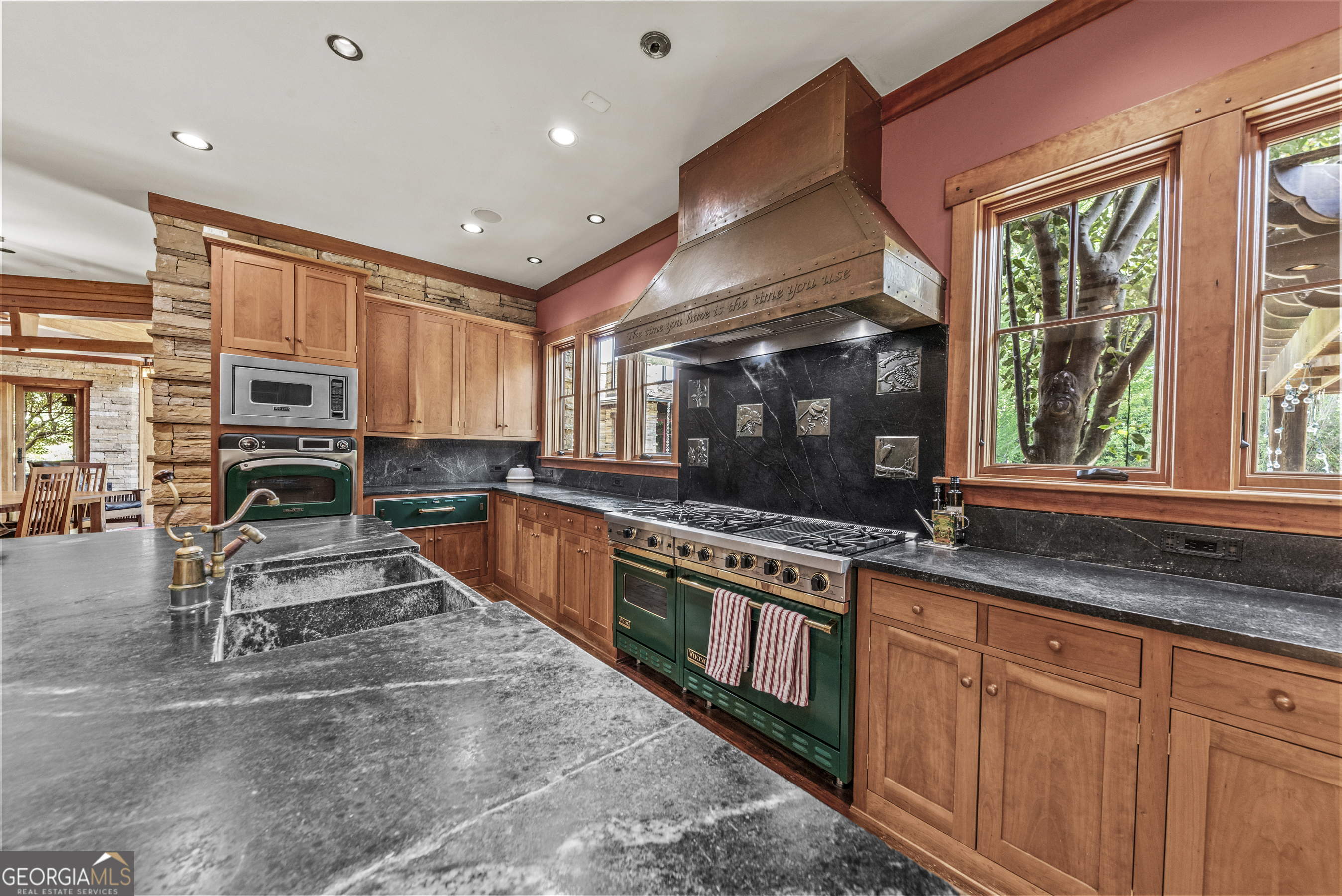 1875 Reids Ferry Road Buckhead, GA 30625 - Photo 23 of 125 a kitchen with stainless steel appliances granite countertop a stove top oven a sink a dining table and chairs
