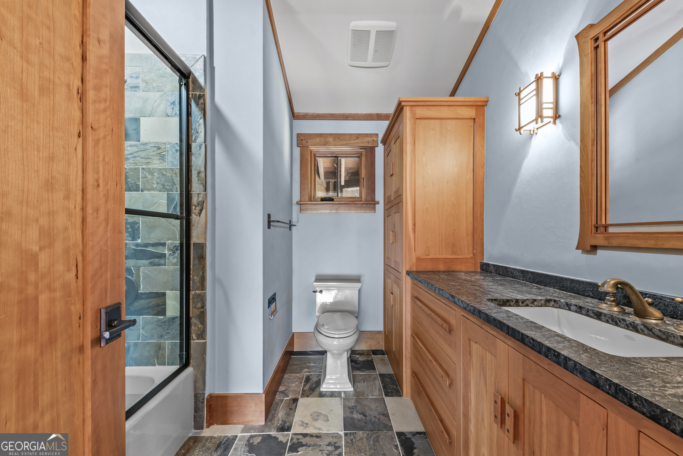 1875 Reids Ferry Road Buckhead, GA 30625 - Photo 65 of 125 a bathroom with a granite countertop sink and a mirror