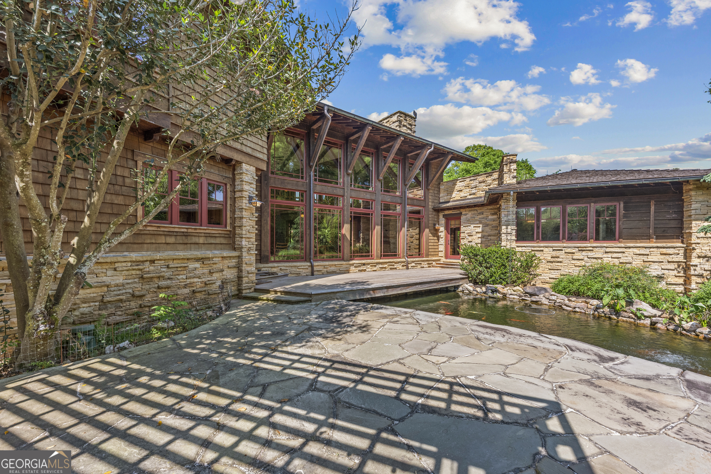 1875 Reids Ferry Road Buckhead, GA 30625 - Photo 76 of 125 a view of a brick house with many windows next to a yard