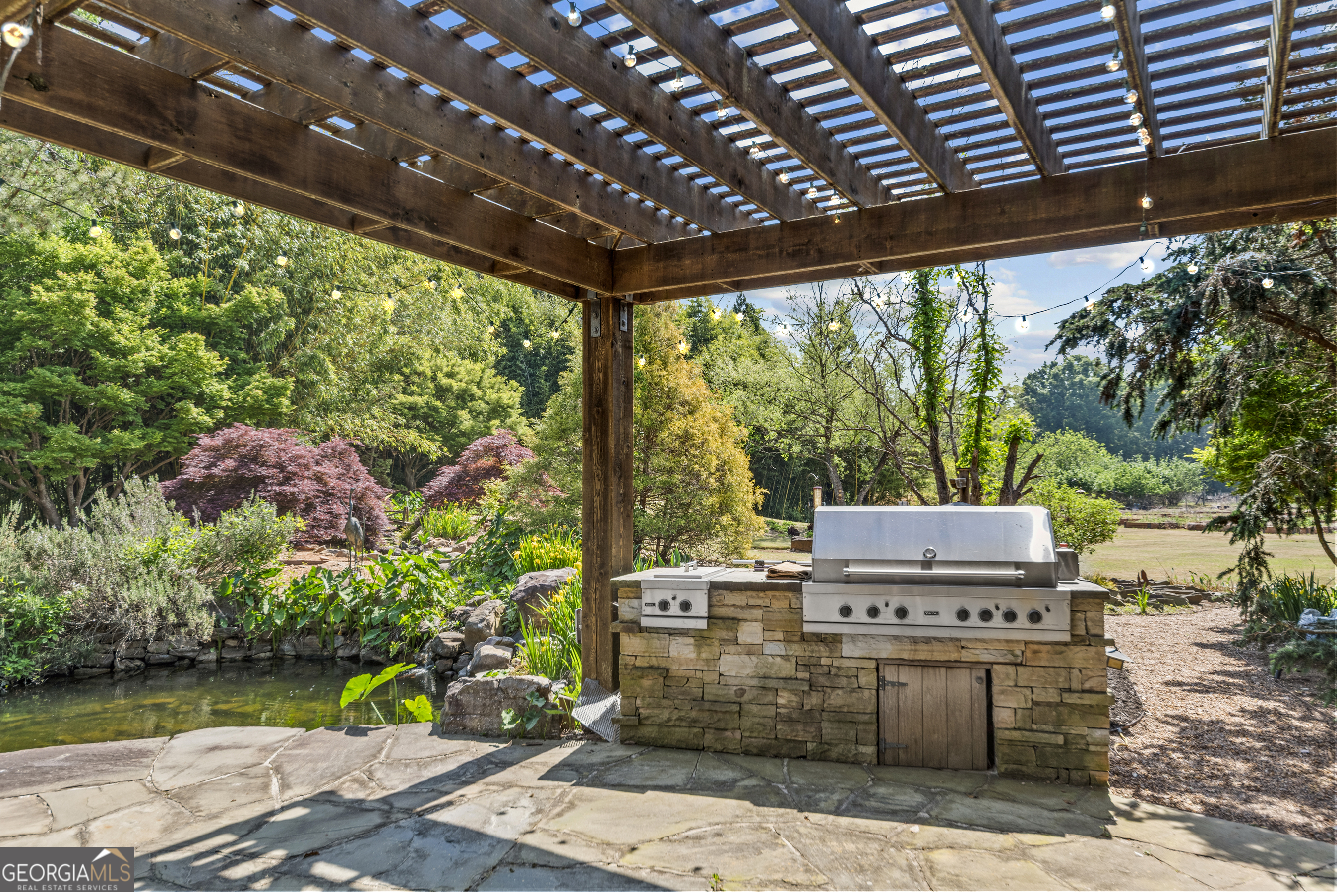 1875 Reids Ferry Road Buckhead, GA 30625 - Photo 77 of 125 a view of a patio with table and chairs potted plants with wooden floor and fence