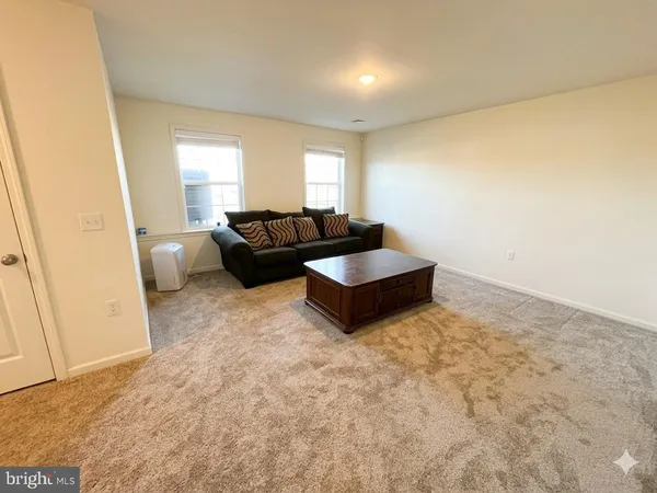 a living room with furniture and a rug
