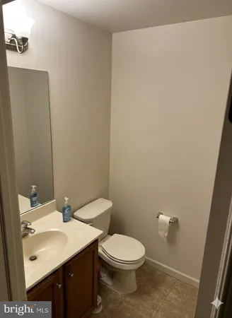 a bathroom with a sink a toilet and mirror