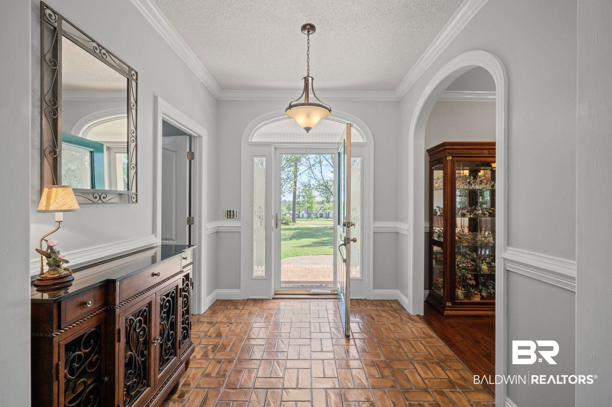 3100 Radcliff Road Saraland, AL 36571 - Photo 5 of 65 Entryway with arched walkways, brick floor, baseboards, and a textured ceiling