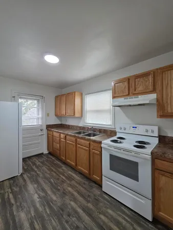 a kitchen with a stove and white cabinets