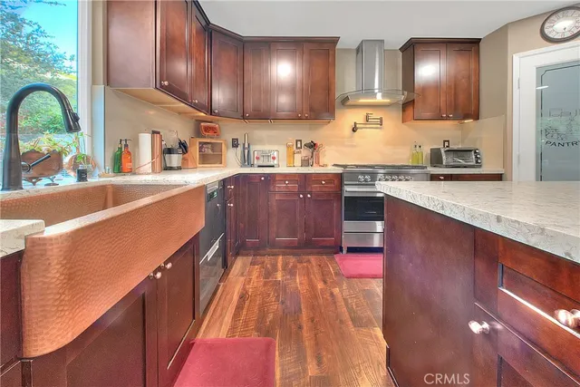 a kitchen with stainless steel appliances granite countertop wooden cabinets a sink and dishwasher
